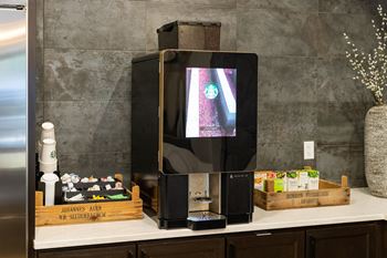 A black television set with a Starbucks advertisement on the screen.